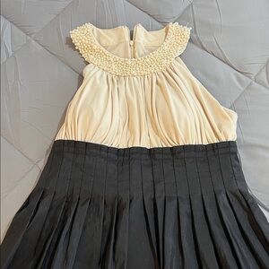 Elegant Cream and Black Dress with Pearl Collar